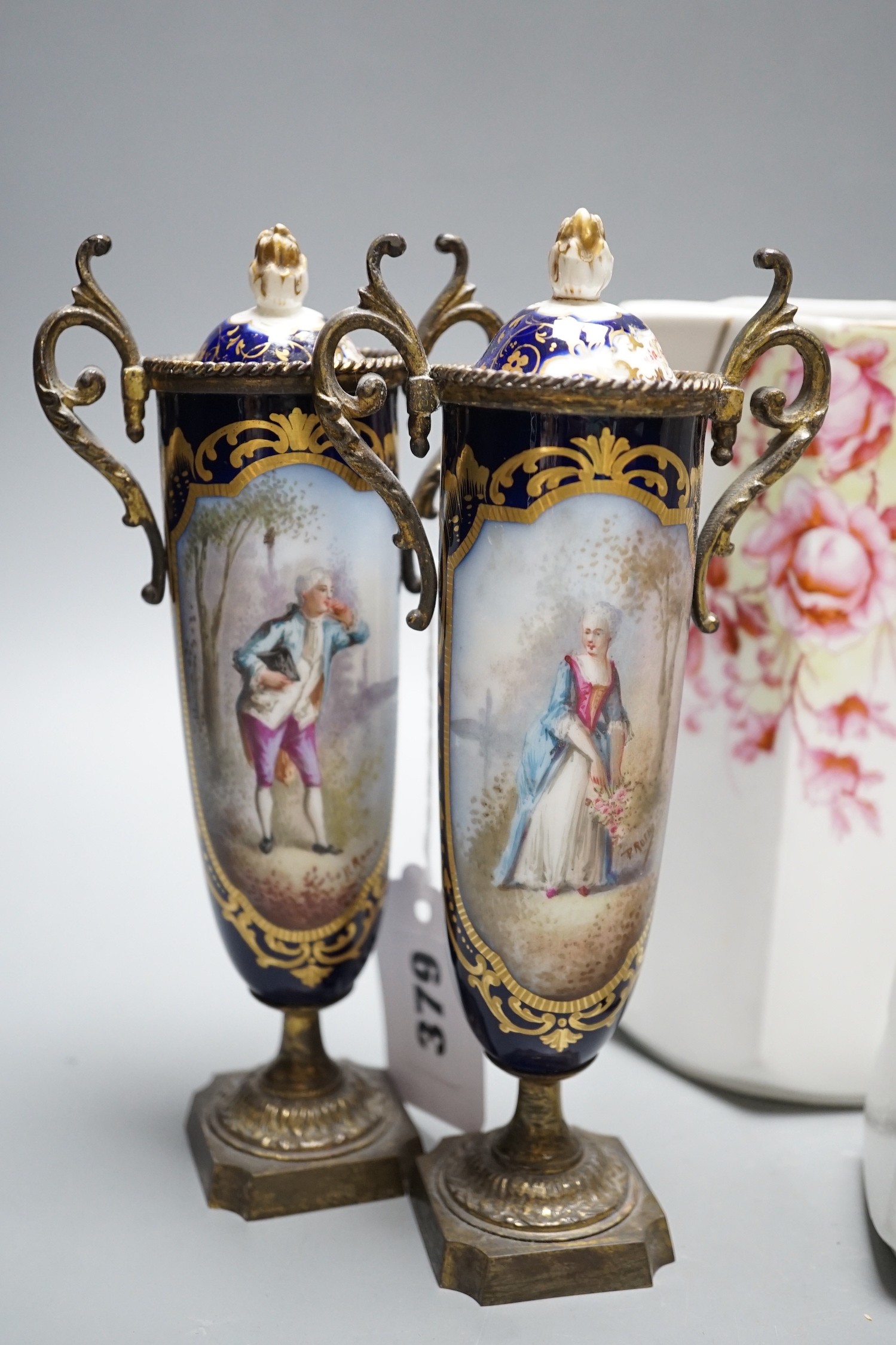 A pair of 19th century French porcelain and gilt metal vases and graded set of three continental porcelain jugs, vases 19cms high